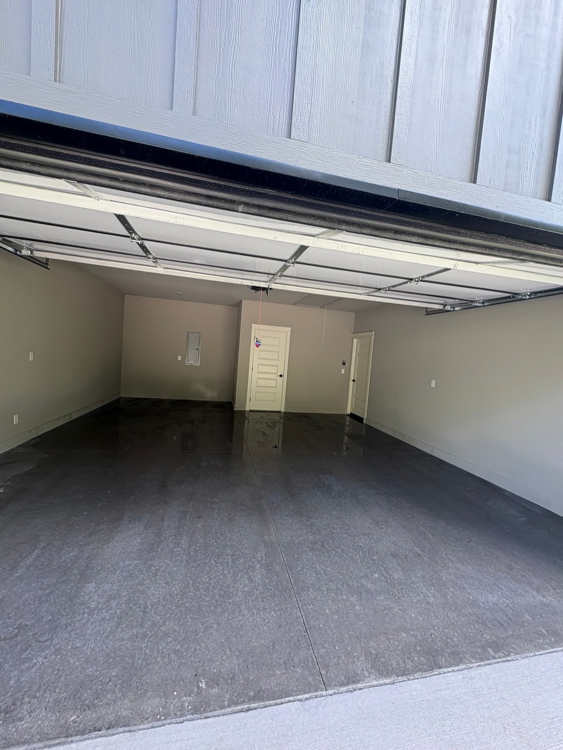 The same garage slab right after chemical steam cleaning, uniform and still damp