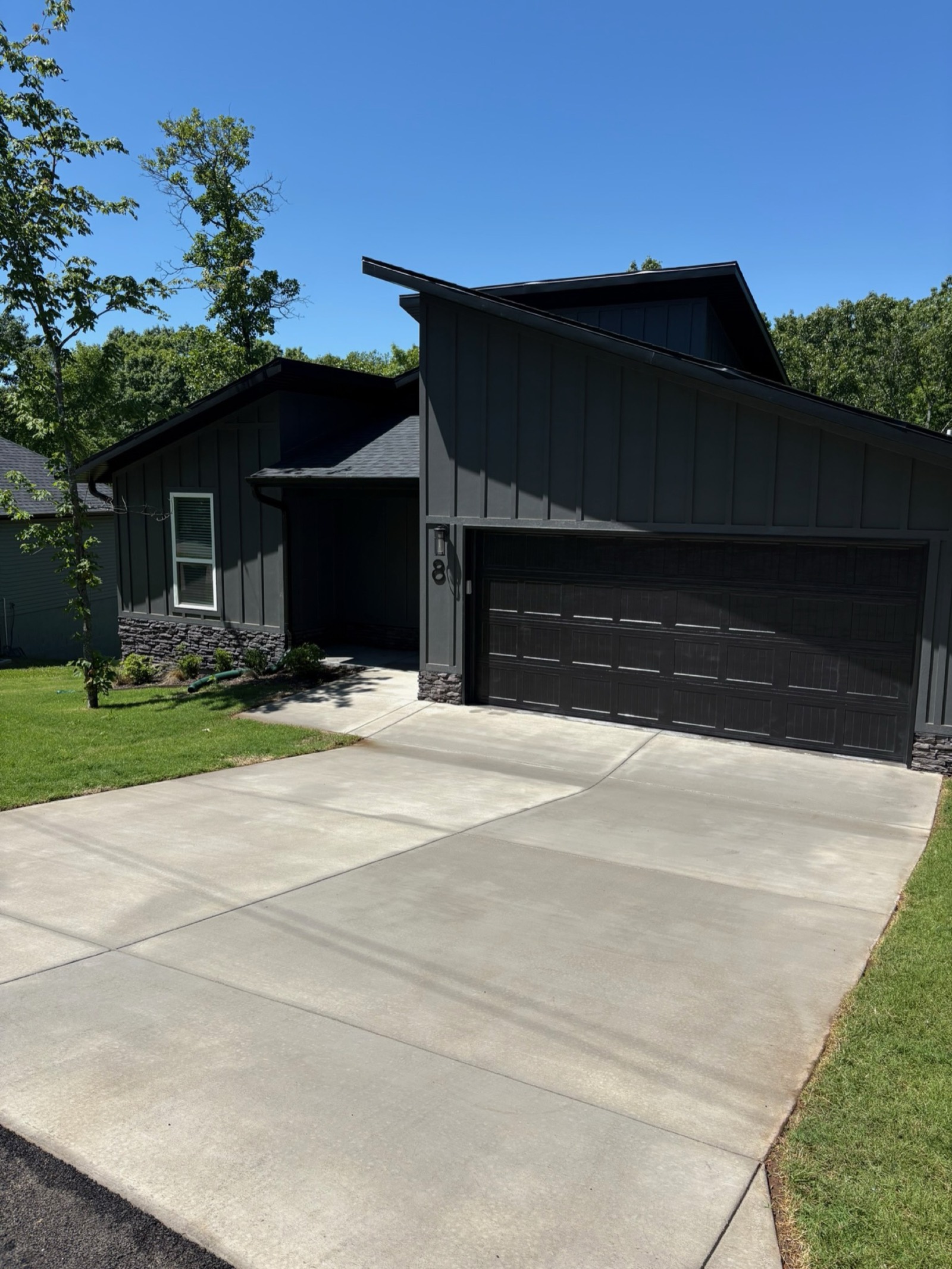 Finished new-construction home with a freshly cleaned driveway